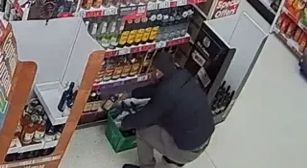 CCTV image of person stealing alcohol