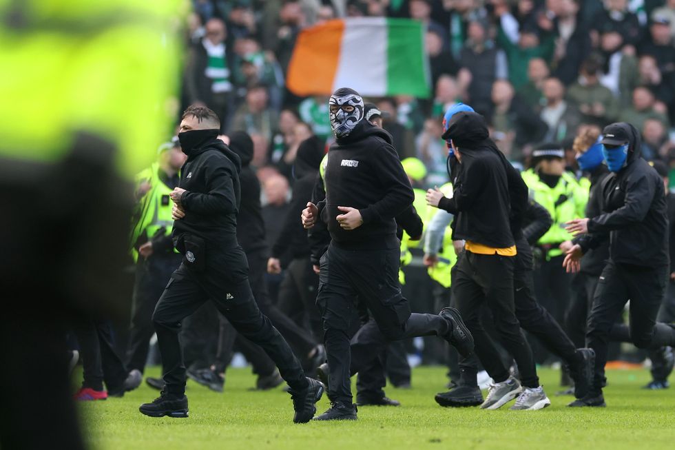 Celtic and Rangers fans clashed on pitch with police eventually restoring order