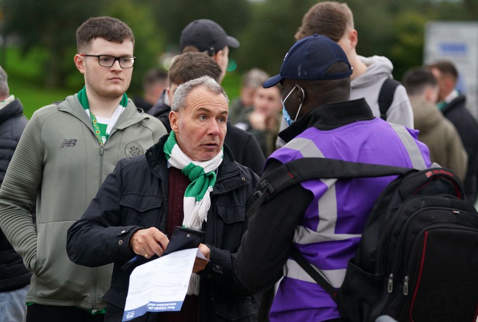 Celtic fans queue to show their vaccine passports as they enter the ground before the UEFA Europa League Group G match at Celtic Park, Glasgow. Picture date: Tuesday October 18, 2021.