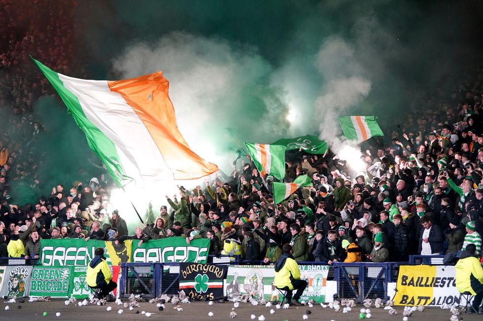 Celtic fans wave flags and light flares in the stands during the Premier Sports Cup Final at Hampden Park.