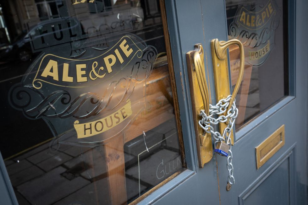 Chains secure the doors of a closed Fuller's pub in London, during England's third national lockdown to curb the spread of coronavirus. Picture date: Thursday January 28, 2021.