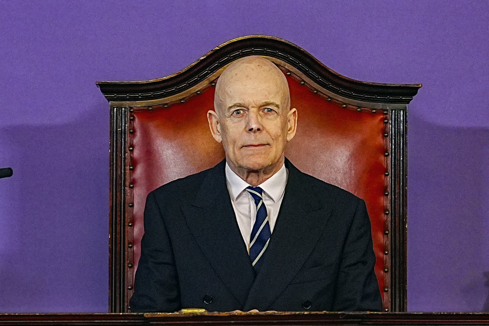 Chair Sir Adrian Fulford sitting inside the hearing room at Liverpool Town Hall