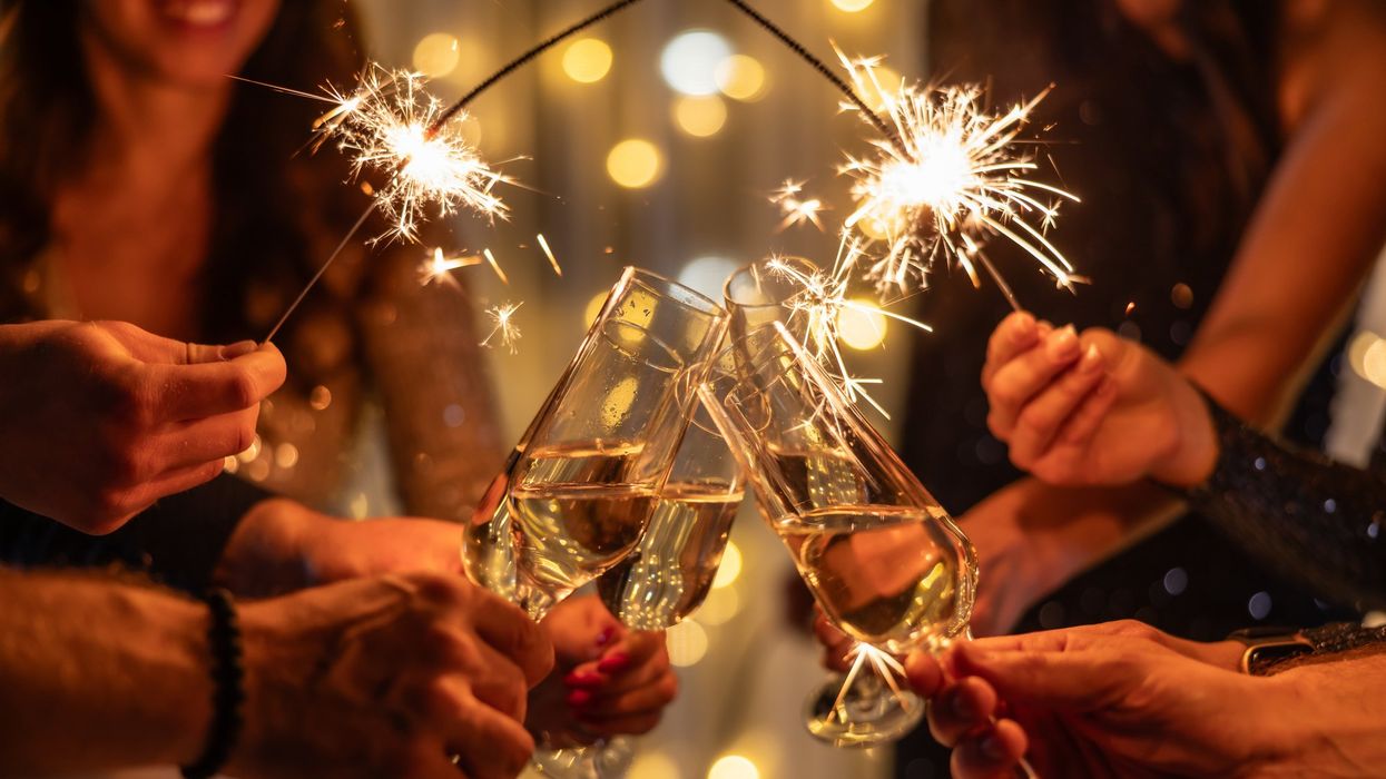 Champagne glasses held up together in a toast
