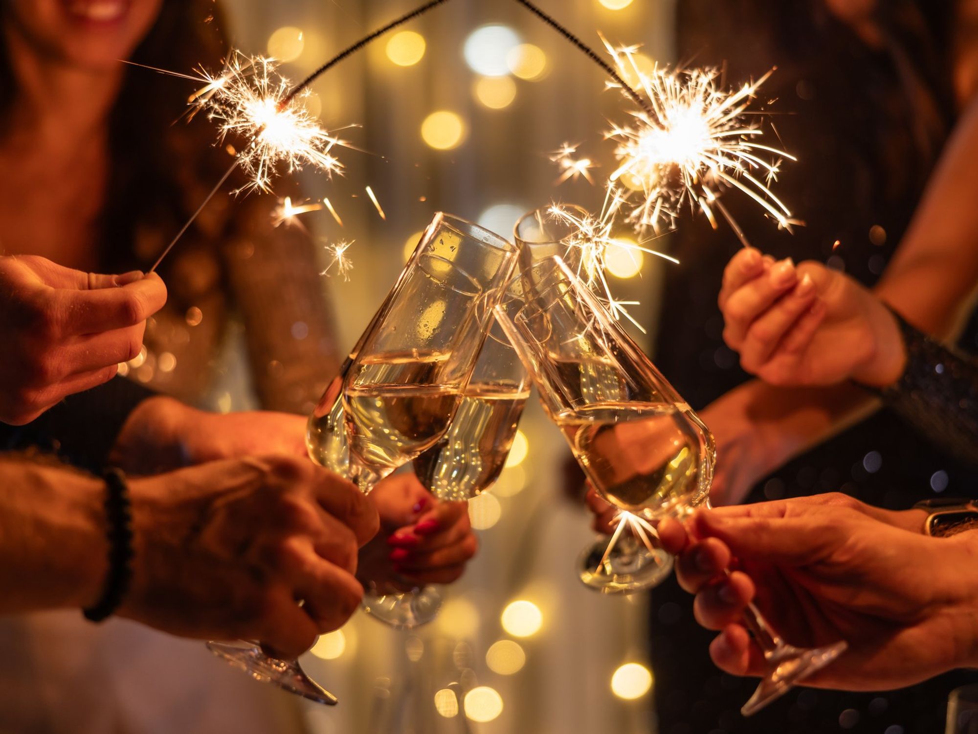 Champagne glasses held up together in a toast
