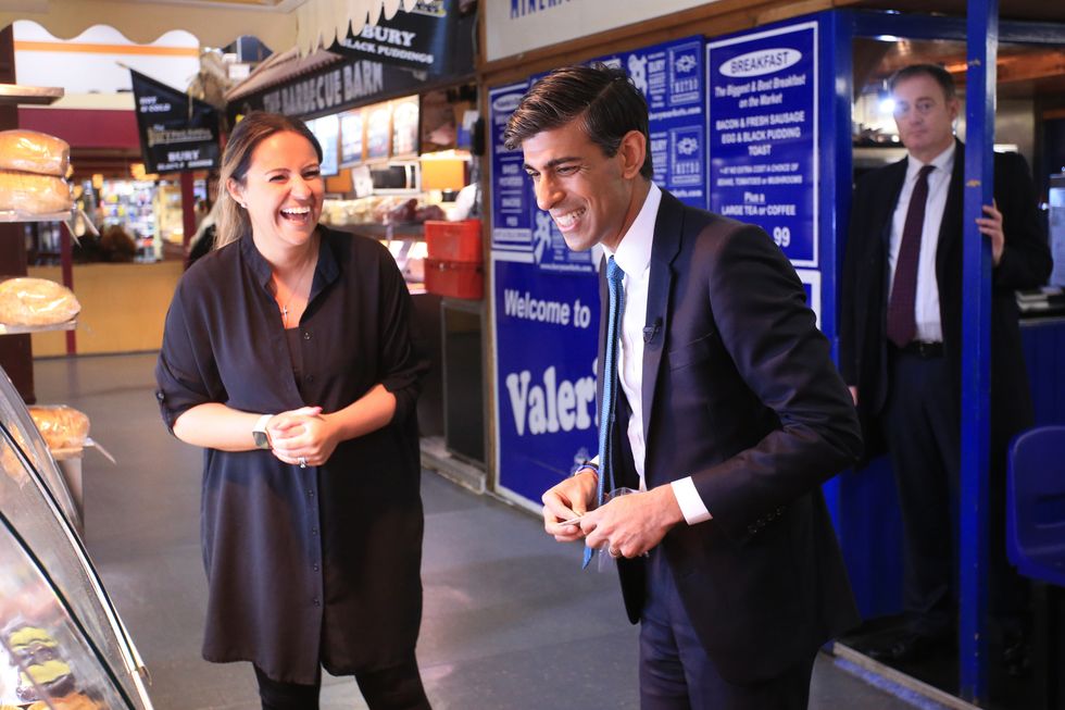 Chancellor of the Exchequer Rishi Sunak laughs during a tour of the Bury Market in Lancashire, the day after presenting his budget to the House of Commons.