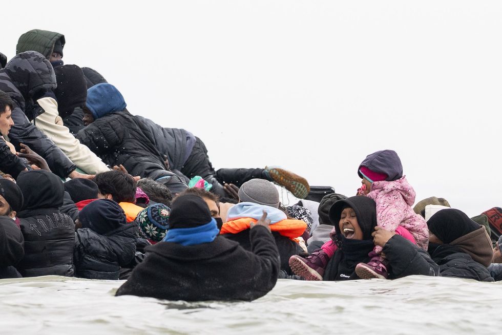 Channel migrants attempting to board a small boat