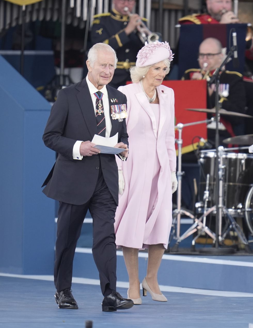 Charles and Camilla walking on stage