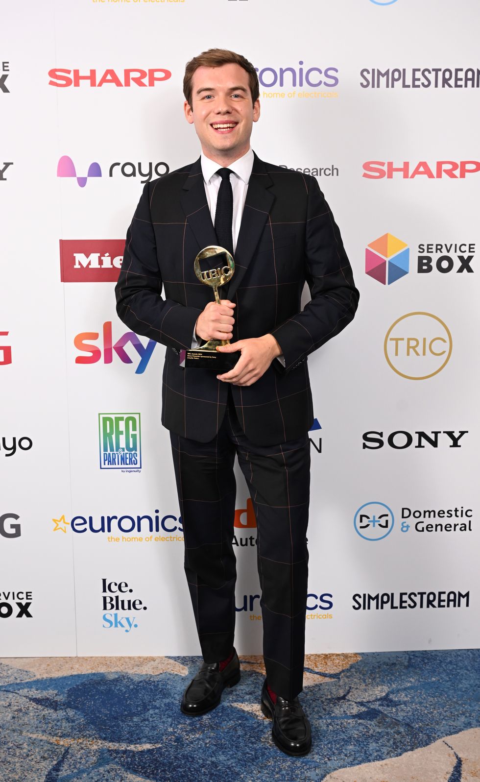 Charlie Peters holds the award aloft