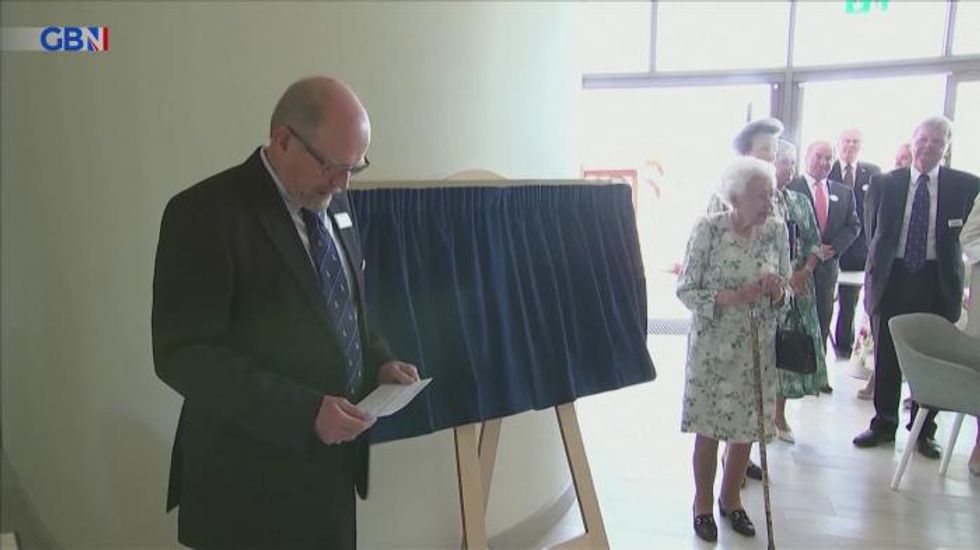 Queen shows off beaming smile as she makes surprise visit to open hospice centre