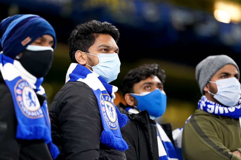 Chelsea fans wear face masks ahead of the Premier League match at Stamford Bridge.