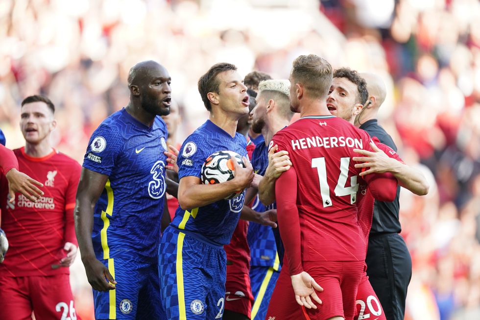 Chelsea's Cesar Azpilicueta (second right) and Liverpool's Jordan Henderson (right) clash following Liverpool's equaliser during the Premier League match at Anfield, Liverpool.