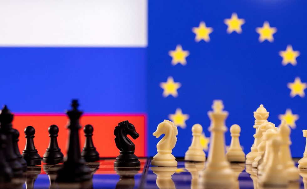 Chess pieces are seen in front of displayed Russian and EU flags in this illustration taken January 25, 2022. REUTERS/Dado Ruvic/Illustration