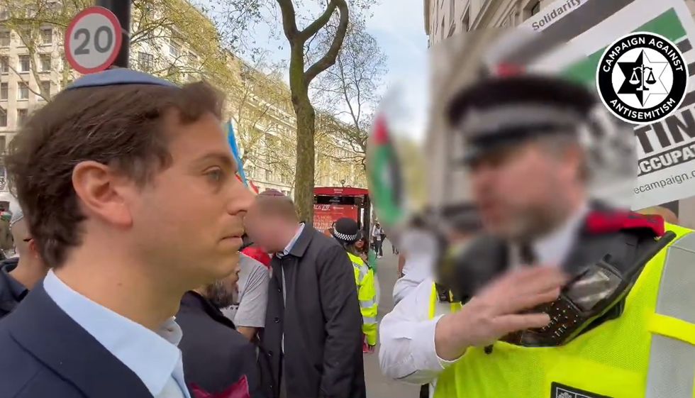 Chief executive Gideon Falter speaking to a police officer