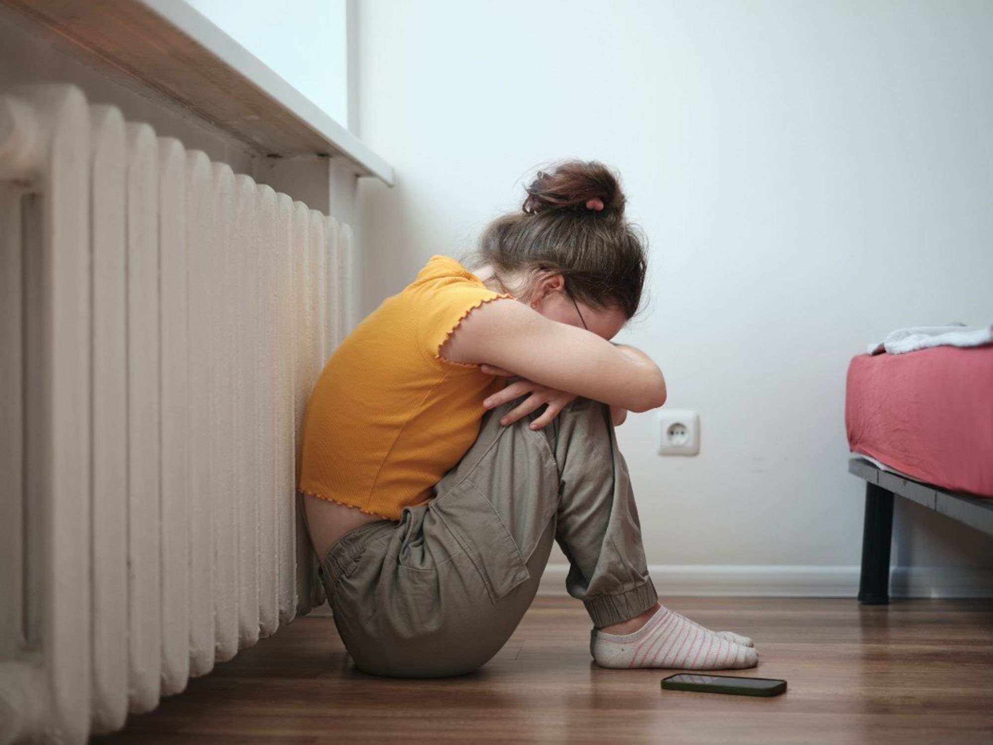 Child crying in front of her phone