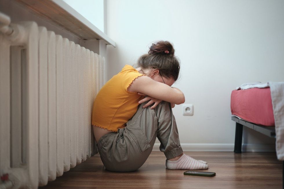 Child crying in front of her phone