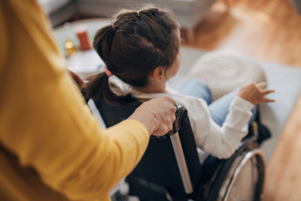 child in wheelchair and spinal x-ray