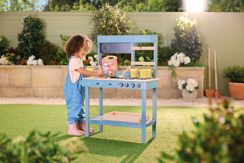 Child playing with Aldi Mud Kitchen