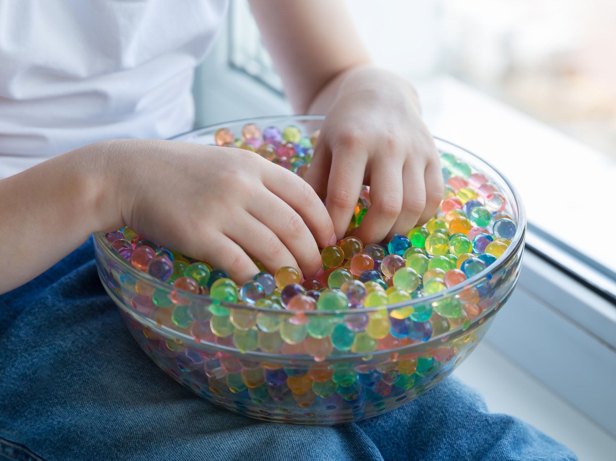 Child playing with water beads