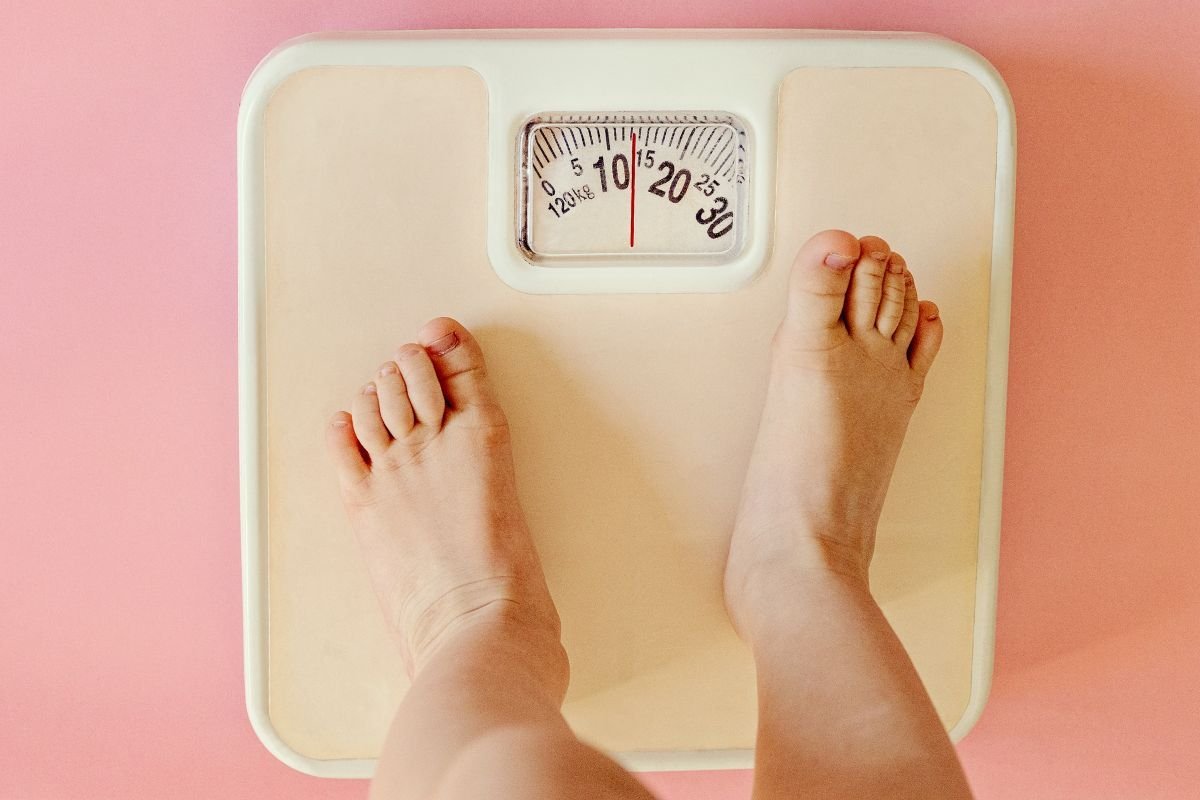 CHILD STANDING ON SCALES