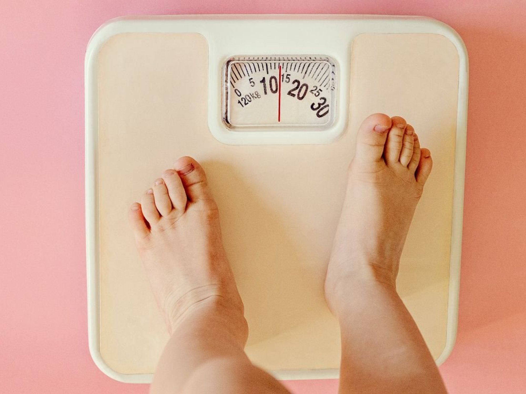 CHILD STANDING ON SCALES