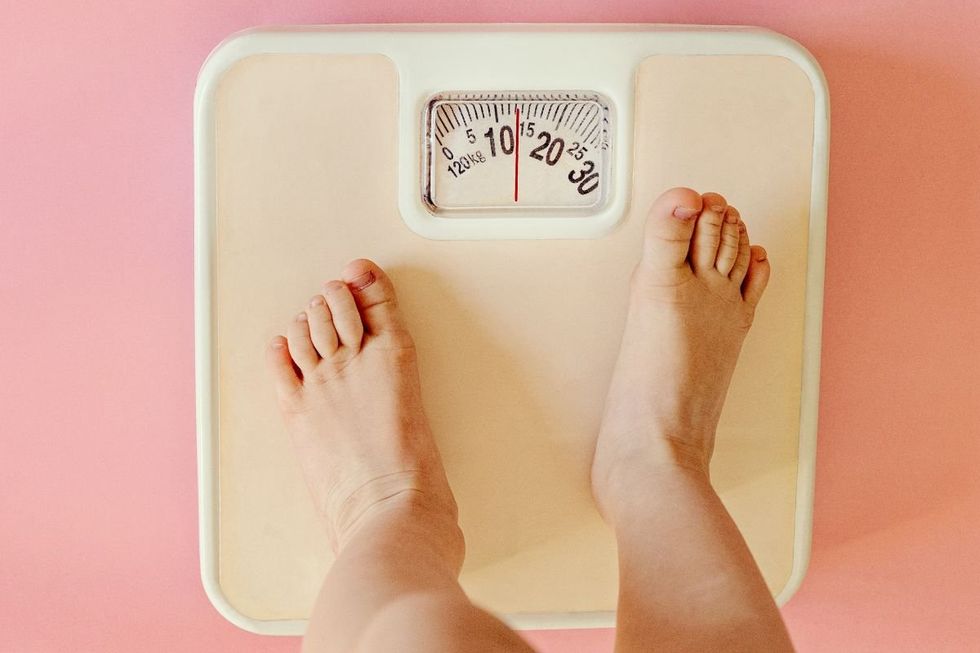 CHILD STANDING ON SCALES