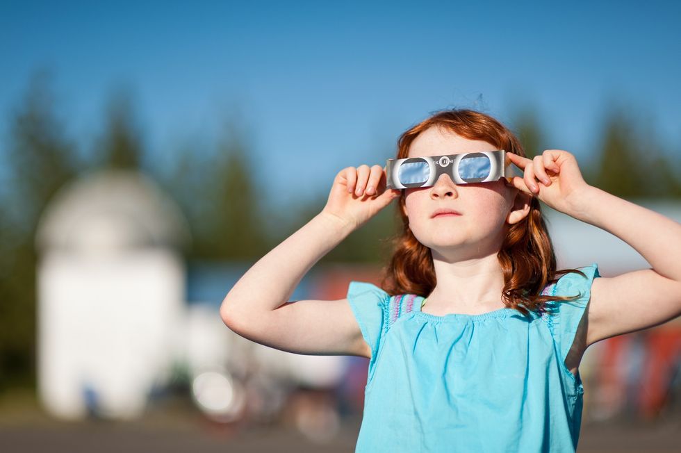 Child wearing eclipse glasses
