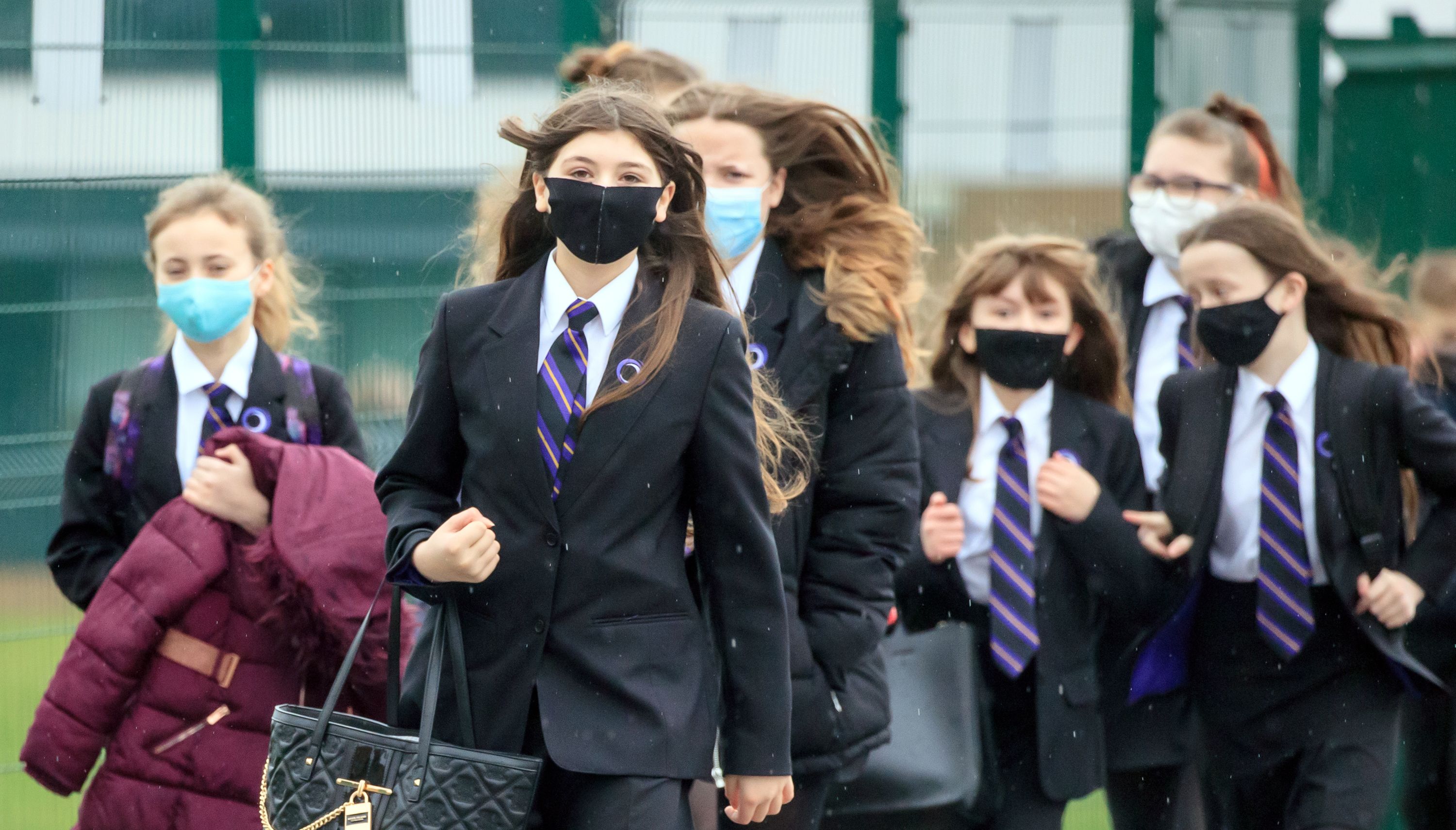 Children arriving at school wearing masks.