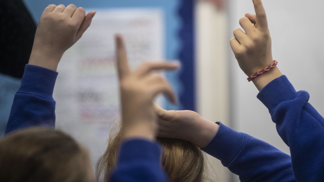 Children put their hands up to ask a question