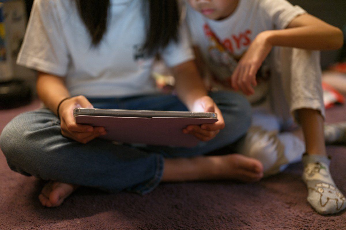 Children using a tablet to access social media