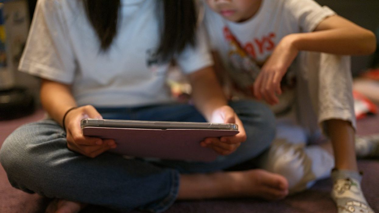 Children using a tablet to access social media