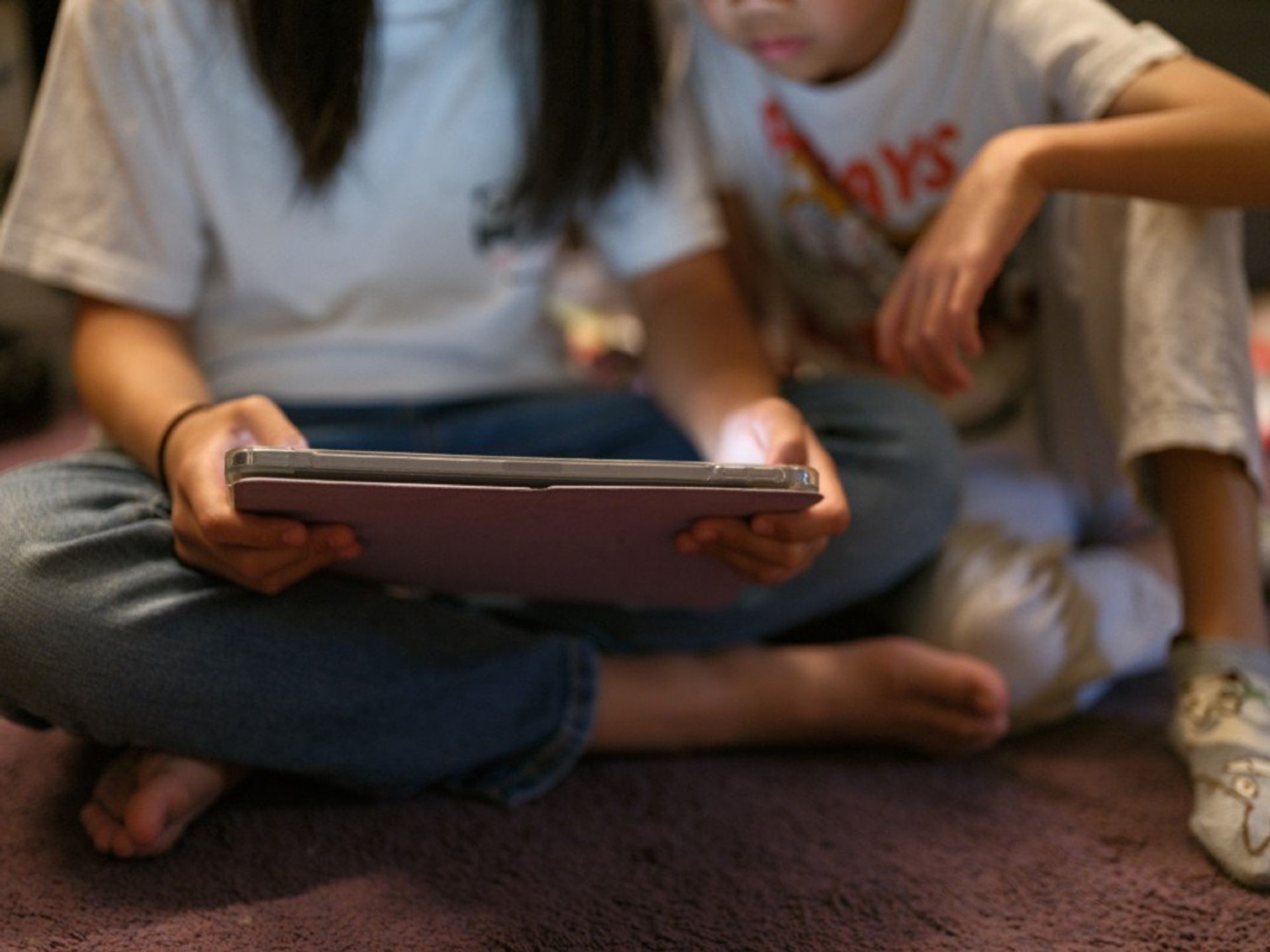 Children using a tablet to access social media