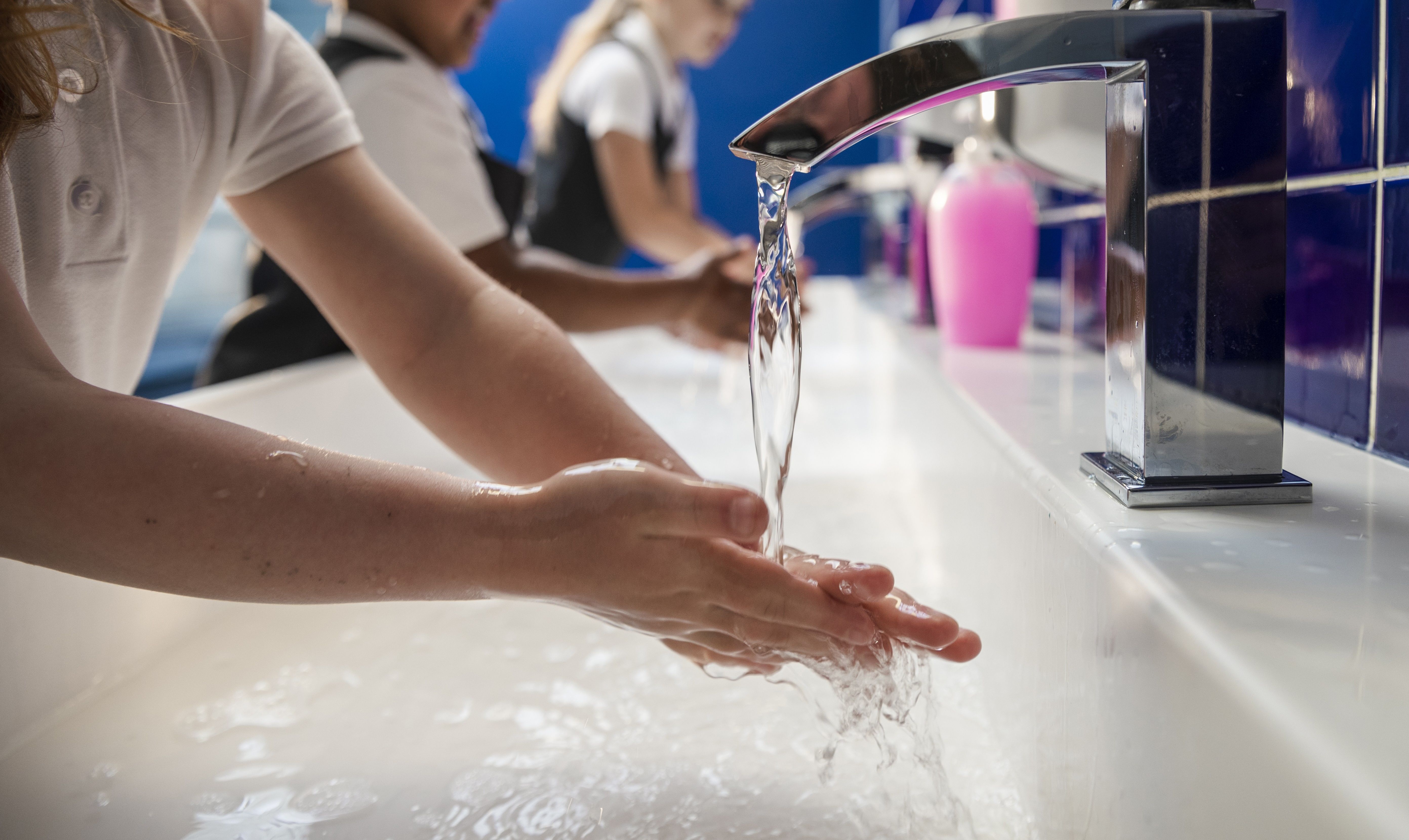 Children wash their hands at school