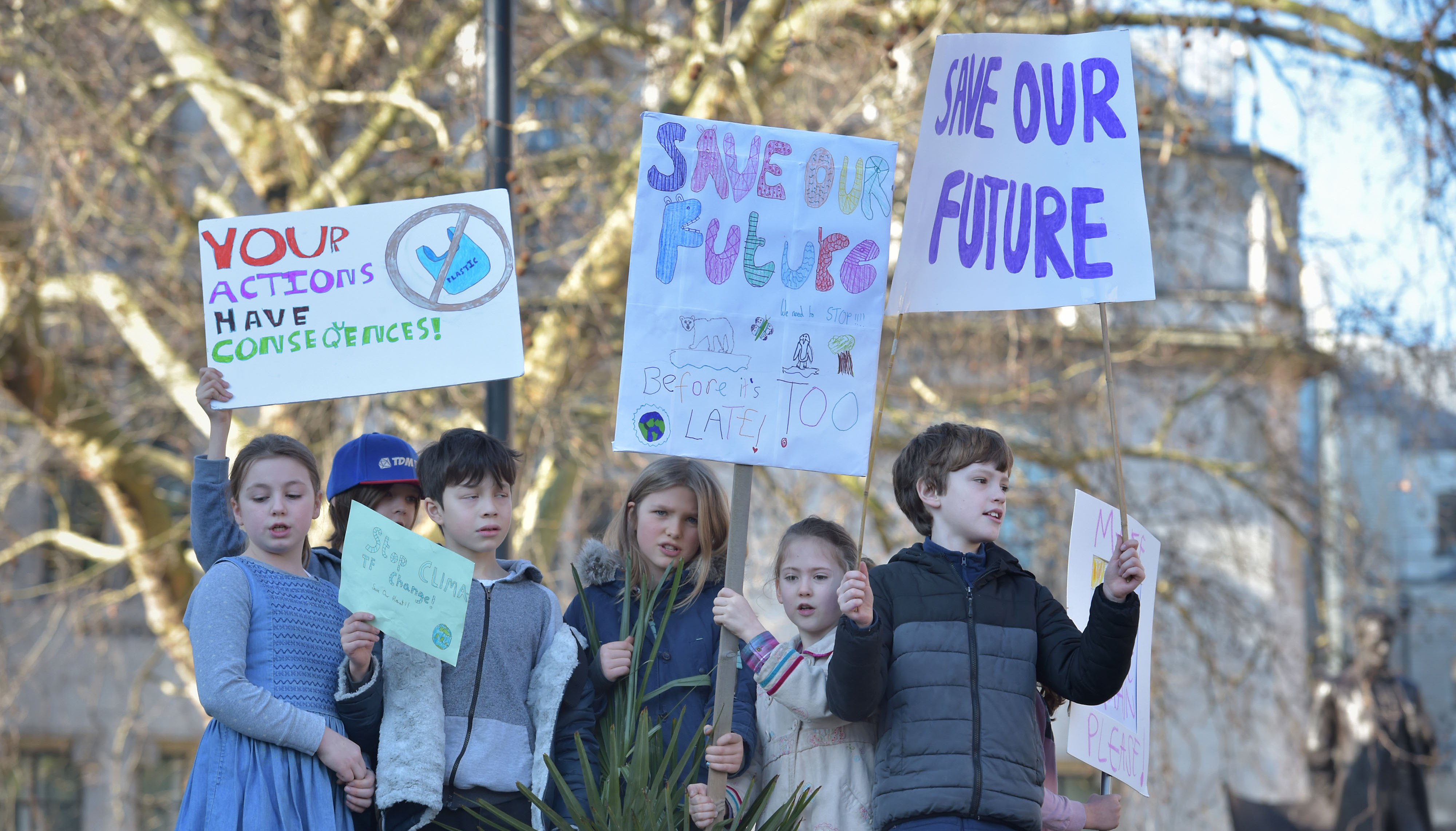 Children with placards during a climate change protest on Parliament Square in Westminster.