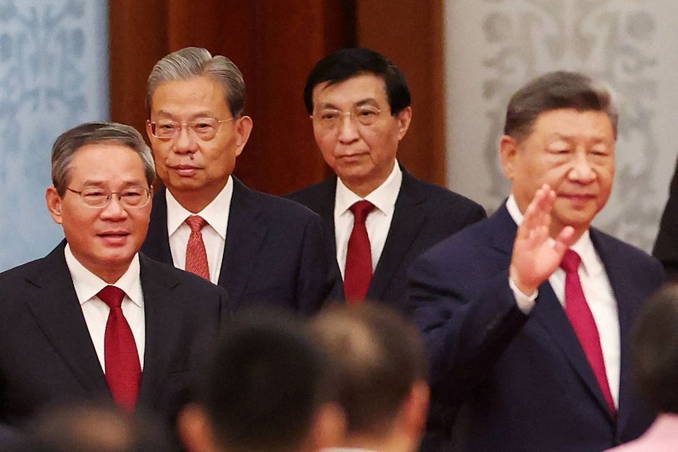 China's President Xi Jinping waves as China's Premier Li Qiang, Chairman of China's National People's Congress Standing Committee Zhao Leji and Chinese People's Political Consultative Conference (CPPCC) Chairman Wang Huning follow him