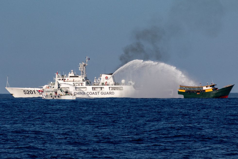 Chinese Coast Guard vessels fire water cannons towards a Philippine resupply vessel