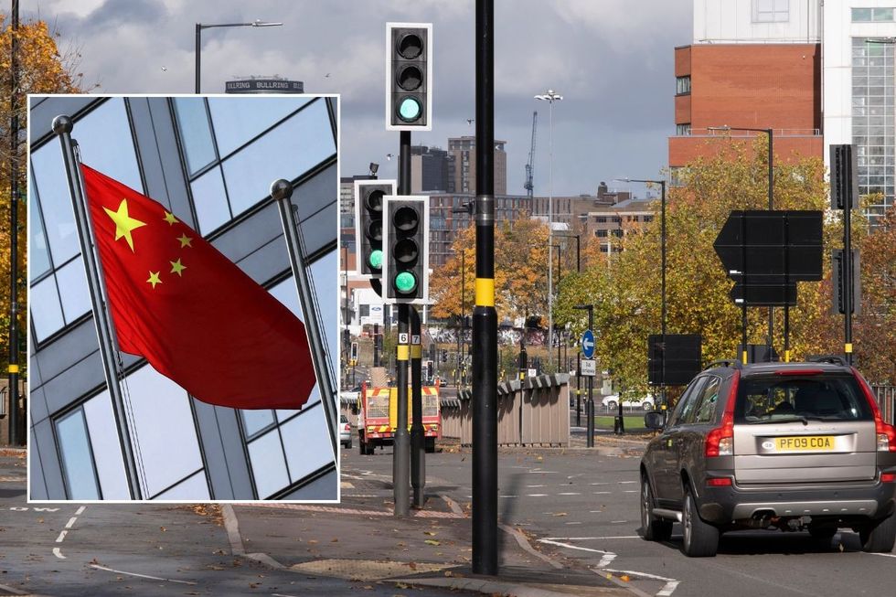 Chinese flag and cars driving past traffic lights