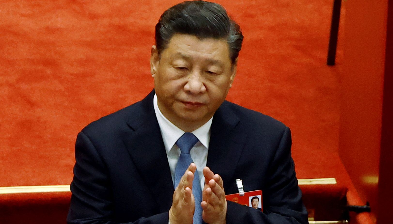 Chinese President Xi Jinping applauds at the opening session of the National People's Congress (NPC) at the Great Hall of the People in Beijing, China March 5, 2022. REUTERS/Carlos Garcia Rawlins