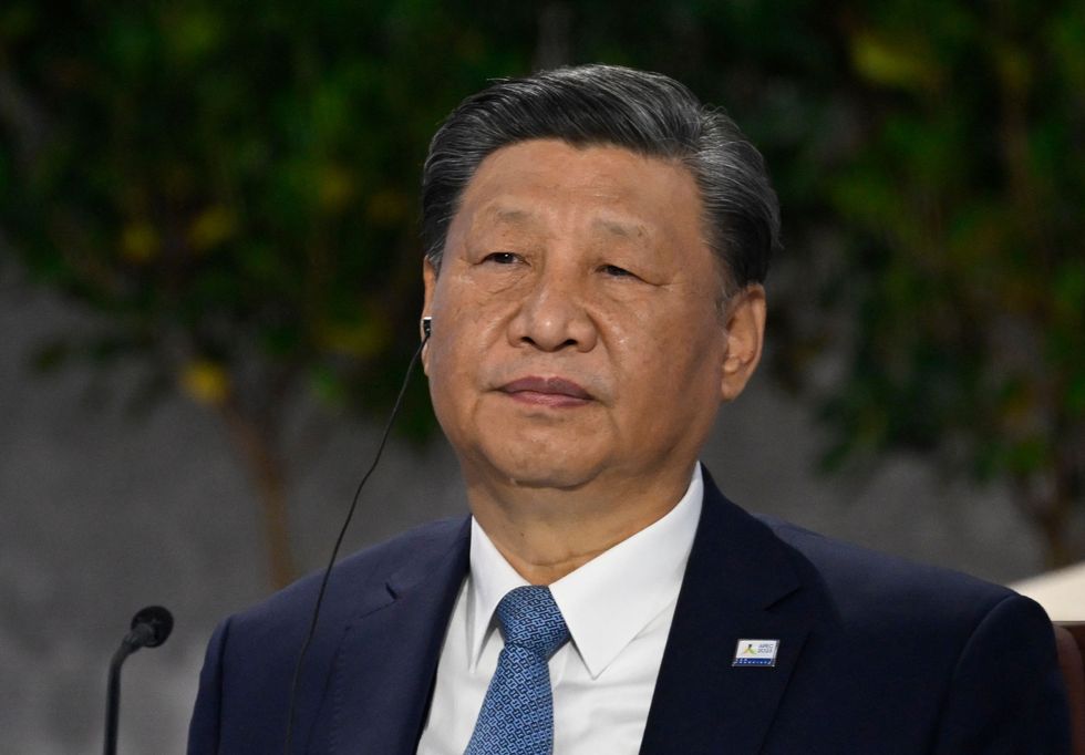 Chinese President Xi Jinping listens during a roundtable meeting with World leaders attending the Asia-Pacific Economic Cooperation (APEC) Leaders' Week