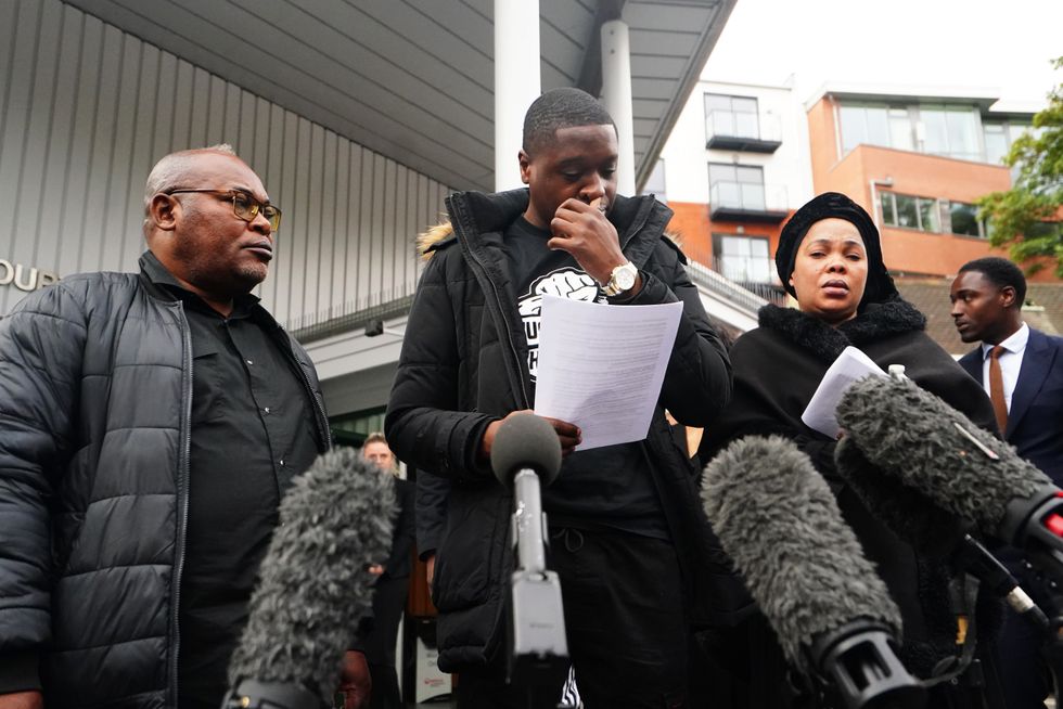 Chris Kaba's cousin Jefferson Bosela reads a statement outside Inner South London Coroner's Court, alongside Chris's parents Prosper Kaba (left) and Helen Lumuanganu after the inquest into his death. Picture date: Tuesday October 4, 2022.