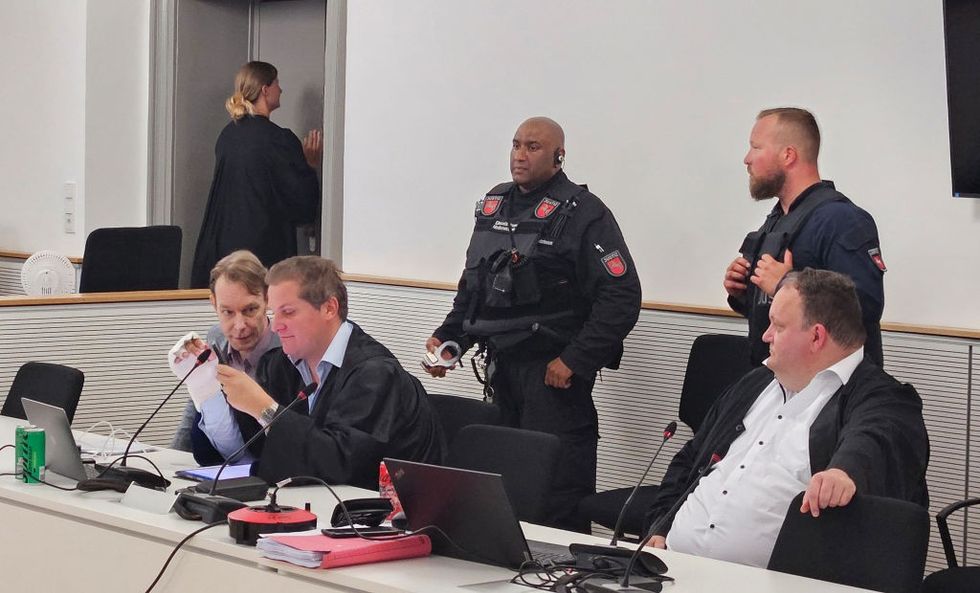 Christian Brueckner (left) sits with lawyers Friedrich Fuelscher (centre) and Philipp Marquort (right)
