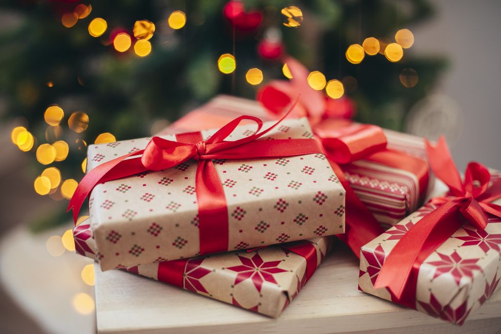 Christmas gift boxes near fir tree