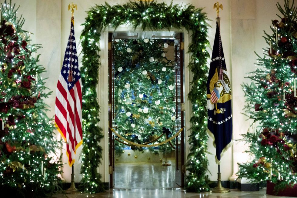 Christmas trees in the Grand Foyer and Blue Room of the White House during a media preview of the 2025 holiday decorations