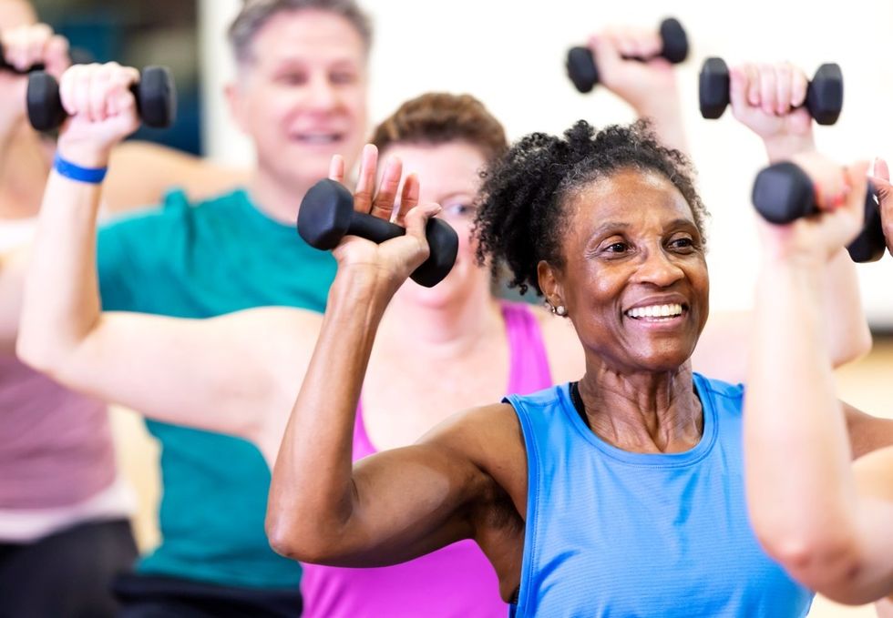 Class of people lifting weights