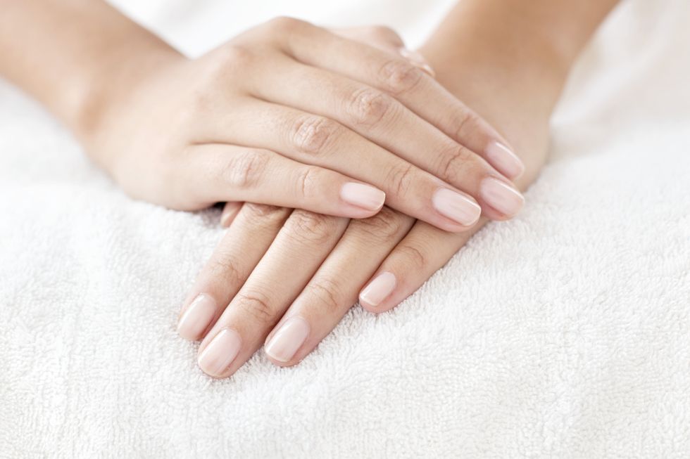Cleanly manicured nails on top of a white towel