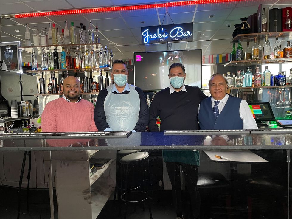 Clifford Rodrigues, 36, Rav Chopra, 44 (wearing the vest scrubs), Raj Chopra, 43 and Jagtar Chopra, 74. Two brothers have been inspired to immunise hundreds of people from their Punjabi grill after their father was admitted to hospital with Covid