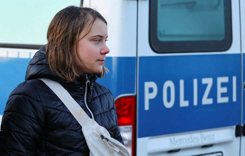 Climate activist Greta Thunberg looks on as police officers detain her on the day of a protest against the expansion of the Garzweiler open-cast lignite mine of Germany's utility RWE to Luetzerath, in Germany, January 17, 2023 that has highlighted tensions over Germany's climate policy during an energy crisis. REUTERS/Wolfgang Rattay