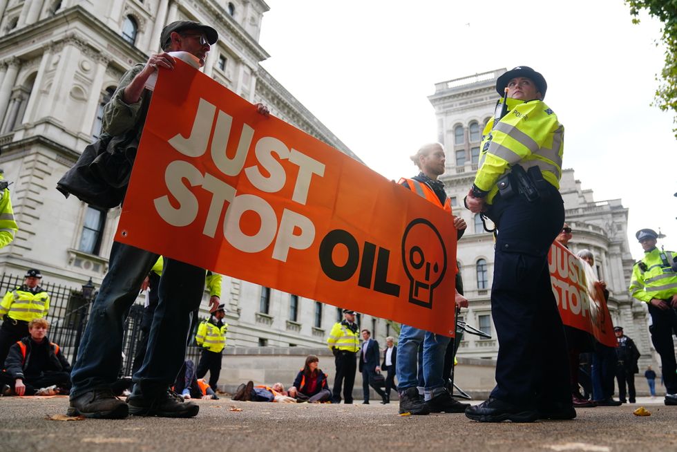 Climate activists from Just Stop Oil take part in a demonstration at the back of Downing Street on Horse Guards Parade, London. Picture date: Wednesday October 12, 2022.