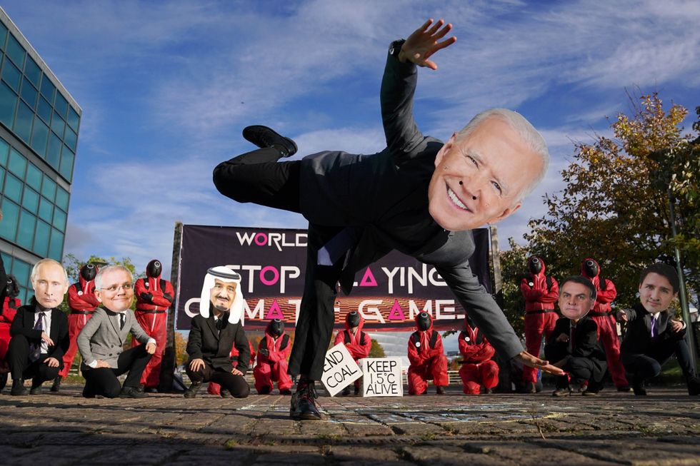 Climate activists from the Glasgow Actions Team, wear Squid Game costumes and world leader masks, play tug of war and climate hopscotch during a protest at the Clyde Arc Bridge during the Cop26 summit at the Scottish Event Campus (SEC) in Glasgow.