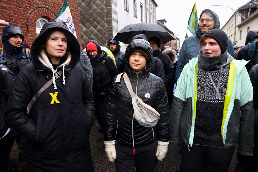 Climate activists Greta Thunberg and Luisa Neubauer take part in a protest against the expansion of Germany's utility RWE's Garzweiler open-cast lignite mine to Luetzerath, in Keyenberg, Germany, January 14, 2023. REUTERS/Christian Mang