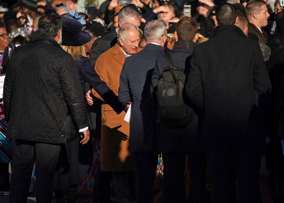 Close-protection officers usher King Charles III out of the way as he was meeting members of the public during a visit to Luton. A man in his 20s has been arrested on suspicion of common assault during a walkabout by the King in Luton town centre after an egg is believed to have been thrown in the direction of the monarch. Picture date: Tuesday December 6, 2022.
